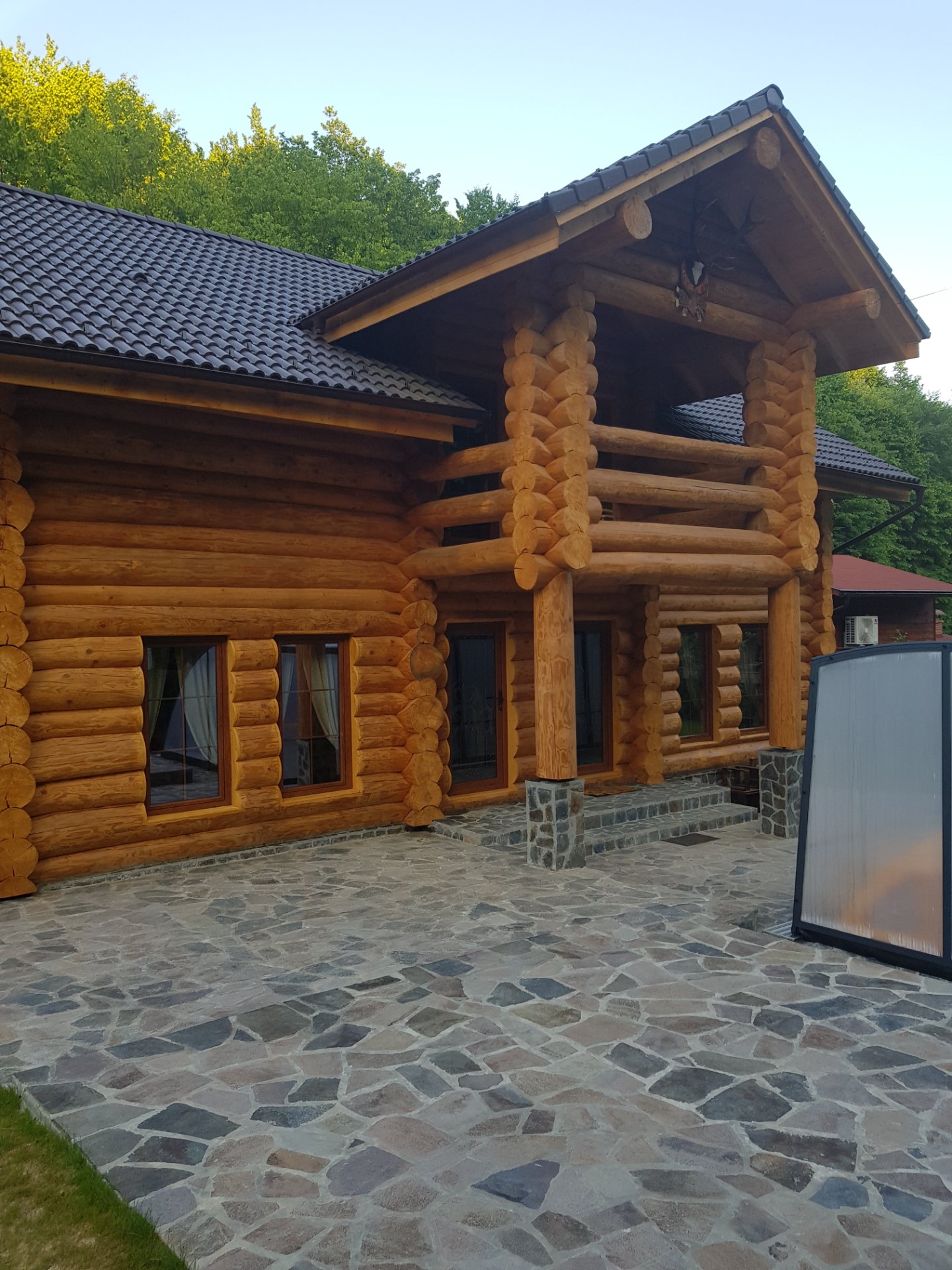 Piscina încălzită a Casei Raiu luminată seara, cu abur deasupra apei